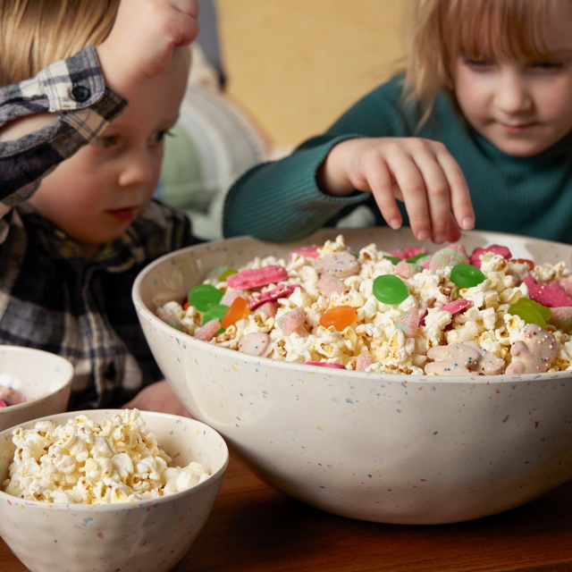 Children sharing a melamine snack bowl